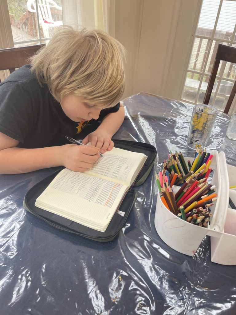 child reading his Bible